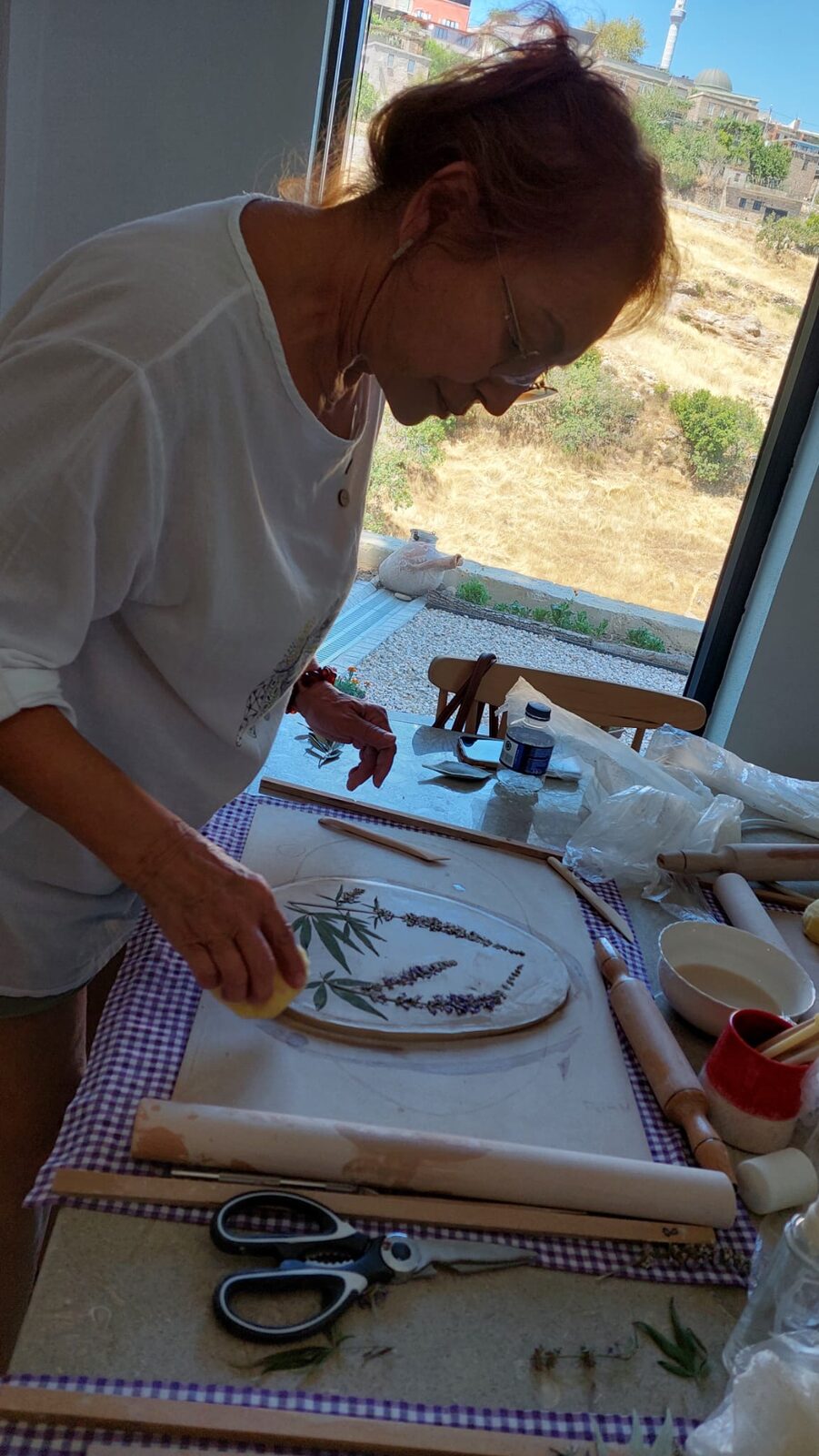 Pressing leaves into a clay slab