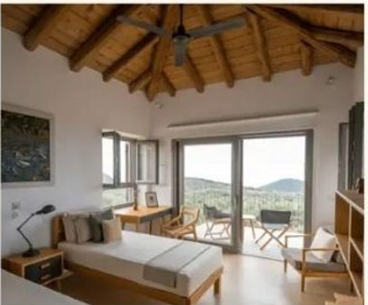 A room with doors opening to the hills