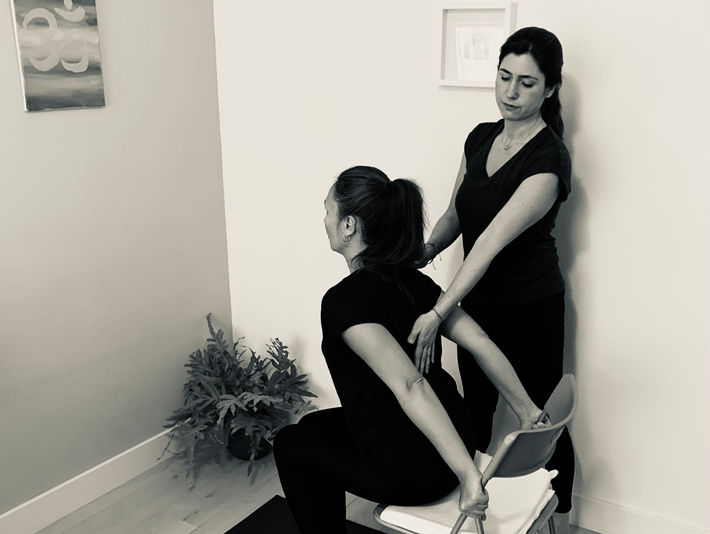 Hands-on guidance during a yoga therapy session