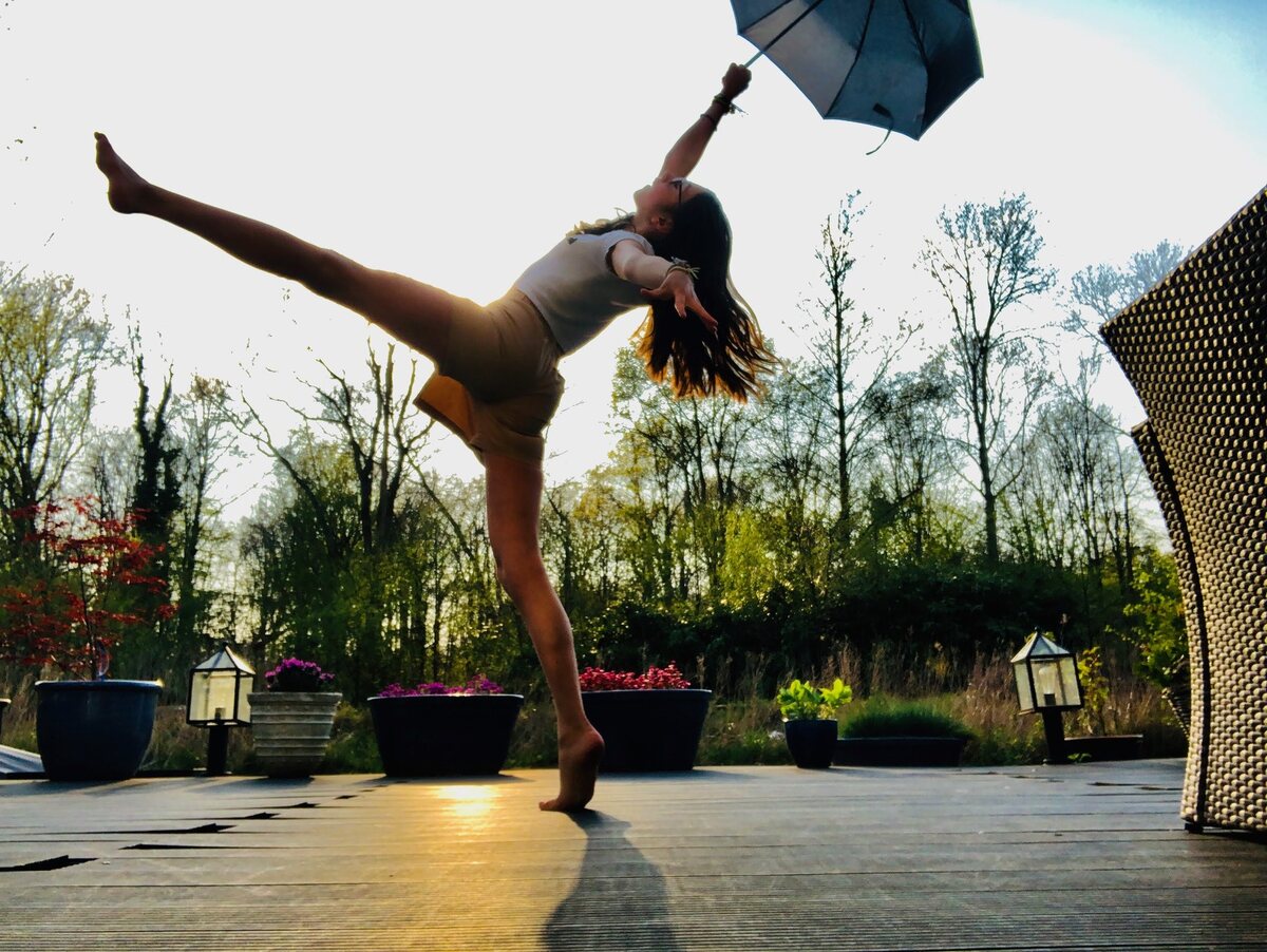 A joyful leap on a terrace in the evening sun